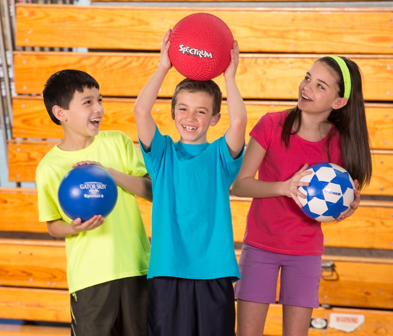 Students playing with a gym ball in Physical Education class